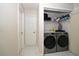 Well-lit laundry room with washer, dryer, and storage shelves at 1100 Lowry Ave # 7, Lakeland, FL 33801