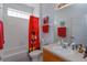 Bathroom with a tub shower combo, red Mickey Mouse theme at 2254 Wyndham Palms Way, Kissimmee, FL 34747