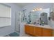 Double vanity bathroom with a walk-in shower and ample storage at 2254 Wyndham Palms Way, Kissimmee, FL 34747