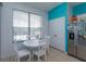 Charming breakfast nook with white table and chairs, overlooking the pool at 2254 Wyndham Palms Way, Kissimmee, FL 34747