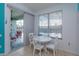 Bright breakfast nook features a white table and chairs near sliding doors to the patio at 2254 Wyndham Palms Way, Kissimmee, FL 34747