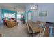 Light wood dining table with six chairs, view of living room at 2254 Wyndham Palms Way, Kissimmee, FL 34747