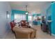 Open living room with brown leather furniture and view of kitchen at 2254 Wyndham Palms Way, Kissimmee, FL 34747