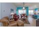 Living room with brown leather furniture and kitchen view at 2254 Wyndham Palms Way, Kissimmee, FL 34747