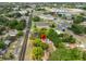 Aerial view of property in residential area with nearby commercial area and lake at 1412 E Main St, Lakeland, FL 33801