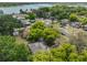 Aerial view of the property and its surroundings, showcasing nearby lake and tree coverage at 1412 E Main St, Lakeland, FL 33801