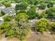 Aerial view of home surrounded by lush greenery and residential streets at 1412 E Main St, Lakeland, FL 33801