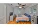 Bedroom features hardwood floors, a ceiling fan, and a large window for plenty of natural light at 1412 E Main St, Lakeland, FL 33801