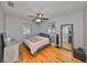 Cozy bedroom with hardwood floors, ceiling fan, and natural light from the large window at 1412 E Main St, Lakeland, FL 33801
