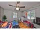 Bedroom features hardwood floors, a ceiling fan, and natural light from the windows at 1412 E Main St, Lakeland, FL 33801