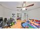 This bedroom features hardwood floors, ceiling fan, a large closet, and a fun, creative atmosphere at 1412 E Main St, Lakeland, FL 33801