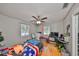 This bedroom features hardwood floors, a ceiling fan, and natural light from the windows at 1412 E Main St, Lakeland, FL 33801