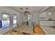 Bright dining room with hardwood floors, stylish light fixture, and a view of the deck through glass doors at 1412 E Main St, Lakeland, FL 33801