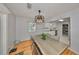 Inviting dining area featuring hardwood floors, modern lighting, and a seamless transition to the stylish kitchen at 1412 E Main St, Lakeland, FL 33801