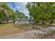 Charming single-story home with a well-maintained lawn and mature trees at 1412 E Main St, Lakeland, FL 33801