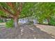 Charming single-story home with mature trees, lush landscaping, and a welcoming front entrance at 1412 E Main St, Lakeland, FL 33801