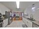 Modern kitchen with white cabinets, granite countertops, stainless steel appliances, and open view to dining room at 1412 E Main St, Lakeland, FL 33801