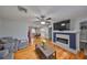 Bright living room features hardwood floors, a fireplace, and an open layout leading to the dining area and kitchen at 1412 E Main St, Lakeland, FL 33801