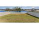 Spacious backyard with a well-maintained lawn and white picket fence, offering serene pond views at 2133 Old Mining Rd, Lakeland, FL 33801