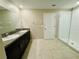 Modern bathroom featuring a glass enclosed shower and double sink vanity at 2133 Old Mining Rd, Lakeland, FL 33801