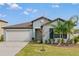 Charming single-story home featuring a well-manicured lawn and a two-car garage at 2133 Old Mining Rd, Lakeland, FL 33801