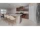 Modern kitchen with dark wood cabinetry, granite counters, stainless appliances, and a breakfast bar at 2133 Old Mining Rd, Lakeland, FL 33801