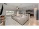 Open-concept living space with a comfortable sofa and views of the modern kitchen and dining area at 2133 Old Mining Rd, Lakeland, FL 33801