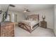 The spacious main bedroom boasts a ceiling fan, dresser, side tables and a large bed at 2133 Old Mining Rd, Lakeland, FL 33801