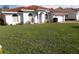 Single story home with a large green lawn and a red tile roof at 252 Golf Aire Blvd, Winter Haven, FL 33884