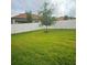 Spacious backyard with green lawn and tree at 4035 Solamor St, Lakeland, FL 33810
