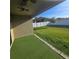 View of the backyard featuring green grass, a white fence and a covered patio at 4035 Solamor St, Lakeland, FL 33810