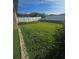 Spacious backyard featuring well-maintained green grass and a white vinyl privacy fence at 4035 Solamor St, Lakeland, FL 33810