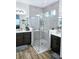 Large bathroom with a walk-in shower, double vanity, and dark brown cabinets at 4035 Solamor St, Lakeland, FL 33810