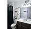 Small bathroom with black shower curtain and dark brown vanity at 4035 Solamor St, Lakeland, FL 33810