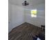 Bedroom with wood-look tile flooring, natural light, and white walls at 4035 Solamor St, Lakeland, FL 33810