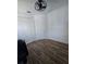Bedroom with wood-look tile flooring, modern ceiling fan, and double door closet at 4035 Solamor St, Lakeland, FL 33810
