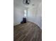 Bedroom with wood-look tile flooring, modern ceiling fan, and double door closet at 4035 Solamor St, Lakeland, FL 33810