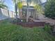Charming home featuring beautiful landscaping, palm trees, and a quaint front porch swing at 4035 Solamor St, Lakeland, FL 33810