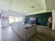 Living room with sectional sofa and a large TV at 4035 Solamor St, Lakeland, FL 33810
