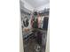 Organized walk-in closet with ample shelving, hanging space and a decorative stool at 4035 Solamor St, Lakeland, FL 33810