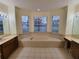Large bathroom with a garden tub and dual vanities at 2912 Sweetspire Cir, Kissimmee, FL 34746