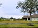 Picturesque view of a pond and homes with lush landscaping at 2912 Sweetspire Cir, Kissimmee, FL 34746