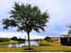 Tranquil community lake with walking path and lush greenery at 2912 Sweetspire Cir, Kissimmee, FL 34746