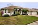 One-story house with a three-car garage and manicured lawn at 2912 Sweetspire Cir, Kissimmee, FL 34746