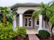 Inviting front entrance with double doors and lush landscaping at 2912 Sweetspire Cir, Kissimmee, FL 34746