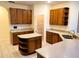 Spacious kitchen with an island, wood cabinets, and neutral countertops at 2912 Sweetspire Cir, Kissimmee, FL 34746