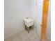 Laundry room with utility sink and built-in shelving at 2912 Sweetspire Cir, Kissimmee, FL 34746