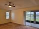 Main bedroom with patio access, carpeting, and a ceiling fan at 2912 Sweetspire Cir, Kissimmee, FL 34746