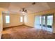 Main bedroom with carpet, ceiling fan, and sliding doors to patio at 2912 Sweetspire Cir, Kissimmee, FL 34746