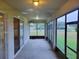 Screened porch with view of backyard and pond at 2912 Sweetspire Cir, Kissimmee, FL 34746